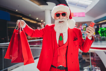 Canvas Print - Photo of popular santa hold phone prepare x-mas presents wear sunglass hat red tux in supermarket mall center