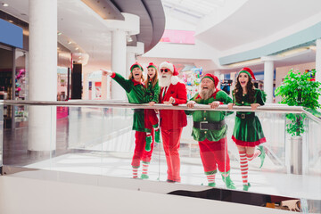 Poster - Full length body size view of attractive cheerful cool elfs pointing dream look advent advert sign at shopping mall indoors