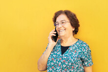 Smiling Aged Woman Talking On Smartphone