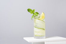 Refreshing Cocktail With Lime And Cucumber Served On White Table