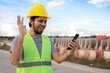 © anut21ng Stock - asian construction worker using smartphone for video call in construction site