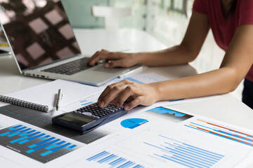 Financial planning and accounting concepts. Women calculate and analyze business and plan their investment finances.