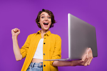 Sticker - Portrait of attractive cheerful lucky skilled girl using laptop rejoicing isolated over bright violet purple color background