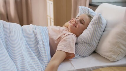 Wall Mural - people, bedtime and sleeping concept - sleepy girl awaking and stretching in bed at home