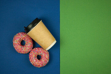 Poster -  paper coffee cup with two doughnuts lie on a green and blue background. A place to copy. Top view. Close-up, copy space, background.