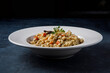 © Macarena - Risotto, Italian rice with mushrooms, vegetables and parsley served on white porcelain plate