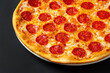 © Maksim Shebeko - Tasty pepperoni and tomatoes on black  background