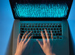 © Andrew Brookes/Westend61 - Hands of hacker coding computer virus on laptop