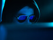 © Andrew Brookes/Westend61 - Cyber Crime, reflection in spectacles of virus hacking a computer, close up of face