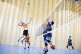 Fototapeta Las - Man jumping during a volleyball match