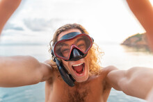 Young Man With Snorkel Making A Face On The Beach