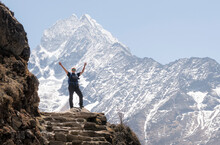 Happy Woman Raisng Arms In Front Of Thamersku Mountain, Himalayas, Solo Khumbu, Nepal