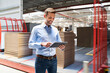 © Bartek Szewczyk/Westend61 - Smiling businessman using tablet in a factory