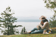 © Crystal Sing/Westend61 - Mother sitting on grass, cuddling her son in nature