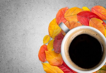 Poster - Hot tea or coffee with fall foliage, cinnamon sticks and star anise. Colorful autumn leaves