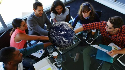 Poster - Animation of rotating globe over group of diverse business team holding hands
