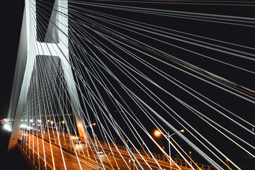 Bridge pylons illuminated in bright white at night, Wroclaw Poland, aerial view