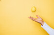 © Daniel Waschnig Photography/Westend61 - Studio shot of hand of person tossing up lemon