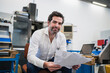 © Daniel Ingold/Westend61 - Portrait of a confident businessman with papers in a factory