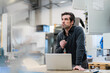 © Daniel Ingold/Westend61 - Portrait of a pensive businessman with laptop in a factory