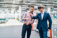 Two Businessmen With AR Glasses In A Modern Factory