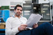 © Daniel Ingold/Westend61 - Portrait of a confident businessman with papers in a factory