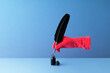 © Dreava Bogdan/Westend61 - Quill pen held in hand and dipping in inkwell over blue background