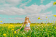 © Westend61 - Young woman in a flower meadow in spring