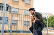 © Eloisa Ramos/Westend61 - Laughing young woman giving her boyfriend a piggyback ride