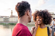 © Francesco Buttitta/Westend61 - Happy young tourist couple at river Arno at sunset, Florence, Italy
