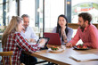 © Florian K√ºttler/Westend61 - Casual business people having a meeting in a cafe