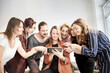 © Jo Kirchherr/Westend61 - Colleagues looking and pointing at mini tablet
