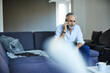 © Jo Kirchherr/Westend61 - Mature man on the phone at home
