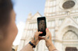 © Francesco Morandini/Westend61 - Woman taking smartphone picture of Santa Croce church, Florence, Italy