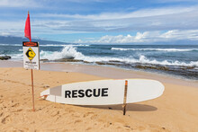Rescue Surfboard, Red Flag And Warning Sign At Ho'okipa Beach Park, Hawaii, USA