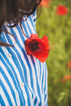 Woman Wearing Red Poppy On Her Blouse, Close-up