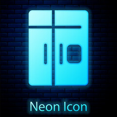 Poster - Glowing neon Refrigerator icon isolated on brick wall background. Fridge freezer refrigerator. Household tech and appliances. Vector