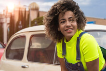Beautiful Smiling Woman Looking Away While Leaning On Car