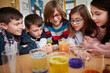 © Westend61 - Group of children in a science chemistry lesson