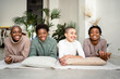 © Rafa Cort√©s/Westend61 - Smiling female friends lying on front in living room