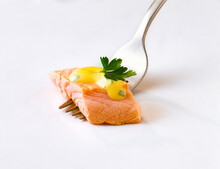 Studio Shot Of Salmon Fillet On Fork With Parsley And Hollandaise Sauce