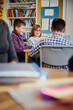 © Westend61 - Group of children in a classroom during a lesson interacting