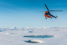 Helicopter Flying Over Melting Ice At North Pole