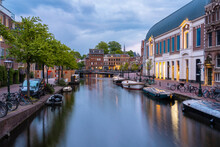 Netherlands, South Holland, Leiden, Boats Moored Along Rhine City Canal At Dusk