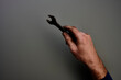 © R.Schmitz/Westend61 - Top view of hand holding screw wrench in front of grey background