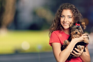 Poster - Beauty young woman holding dog on her arm smile and happiness,