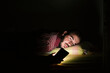 © Westend61 - Man lying in bed using smartphone at night