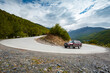 © Valentin Weinhaeupl/Westend61 - Georgia, 4x4 car passing hairpin turn on winding mountain road