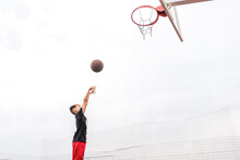 Young Boy Kid Shooting A Basketball In The Hoop