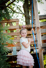 Girl Dressed As A Princess With Crown And Sceptre Playing In A Tree House